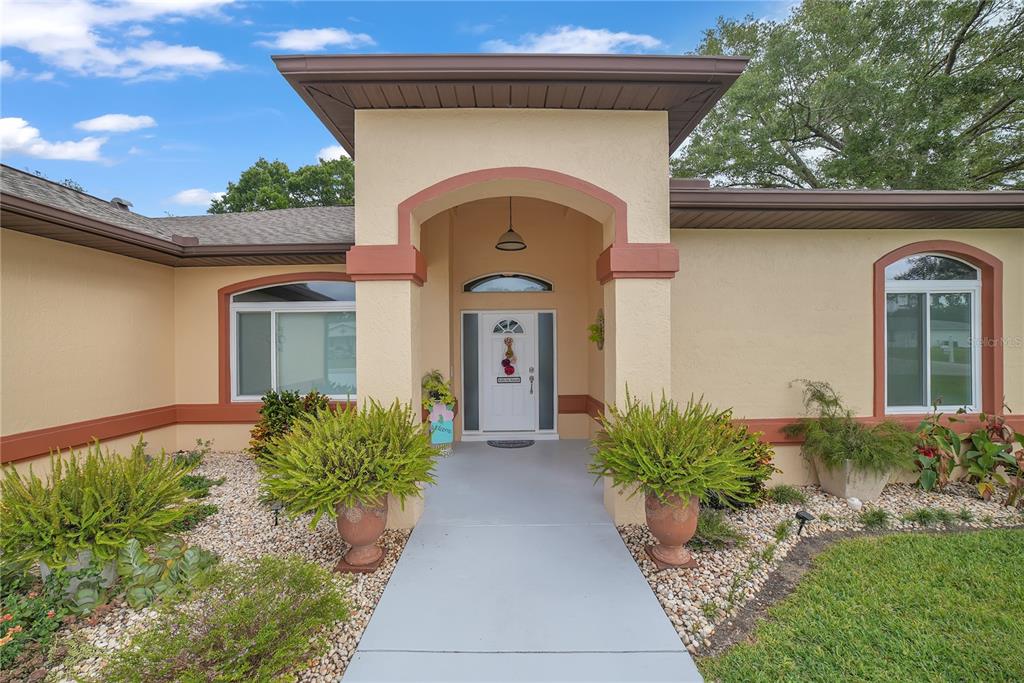 10317 Southwest 63rd Avenue Ocala, FL 34476 - Photo 2 of 46 a front view of a house with garden
