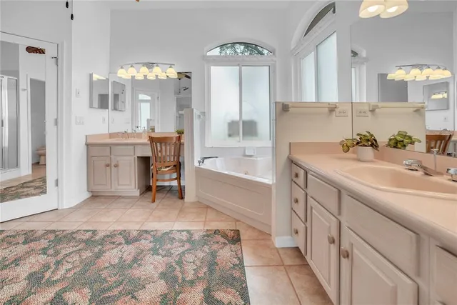 a spacious bathroom with a sink mirror and a bath tub