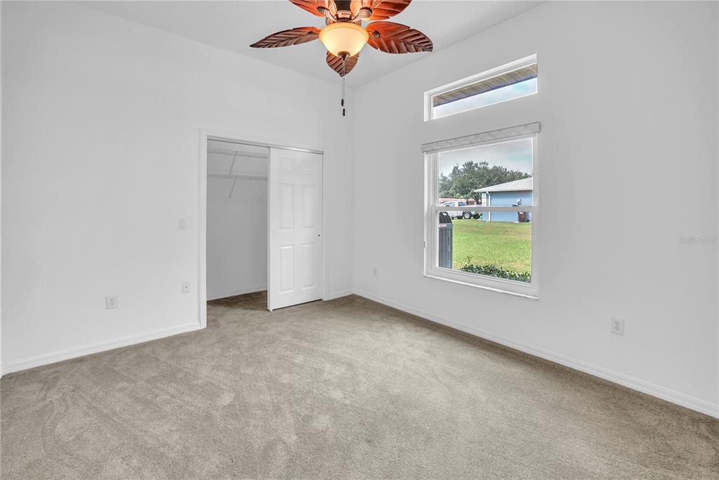 10317 Southwest 63rd Avenue Ocala, FL 34476 - Photo 26 of 46 an empty room with a window and ceiling fan