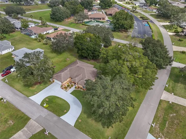 an aerial view of residential houses with outdoor space and street view