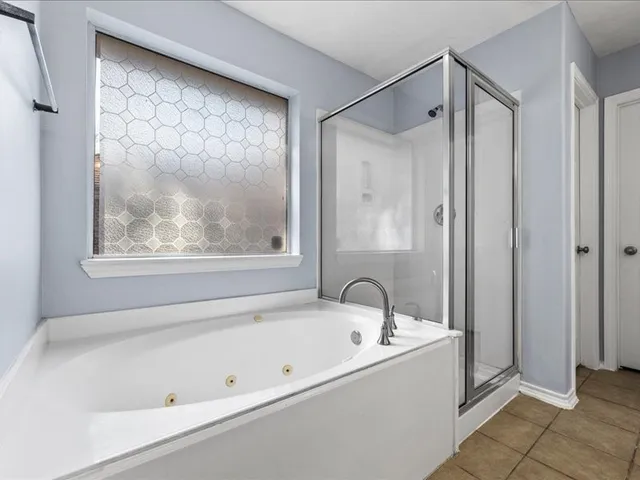a bathroom with a bathtub and a shower