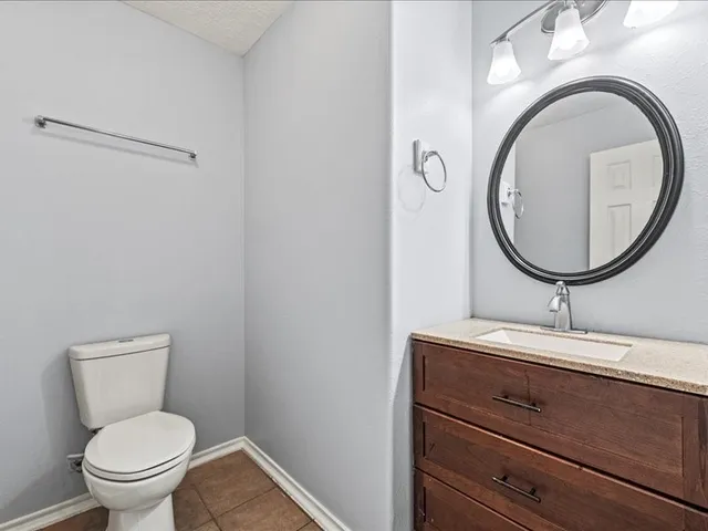 a bathroom with a toilet a sink and a mirror
