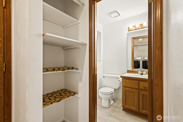 a bathroom with a toilet a sink and a mirror