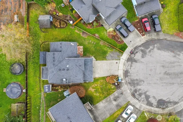 an aerial view of a house with a backyard