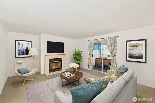 a living room with furniture a flat screen tv and a fireplace