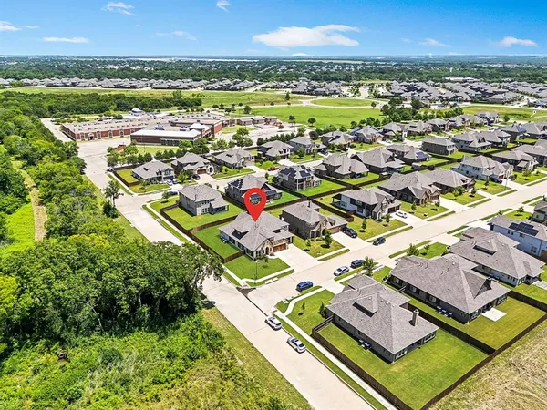 an aerial view of residential houses with outdoor space and river