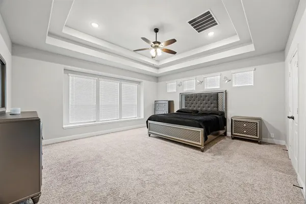 a bedroom with furniture and a ceiling fan