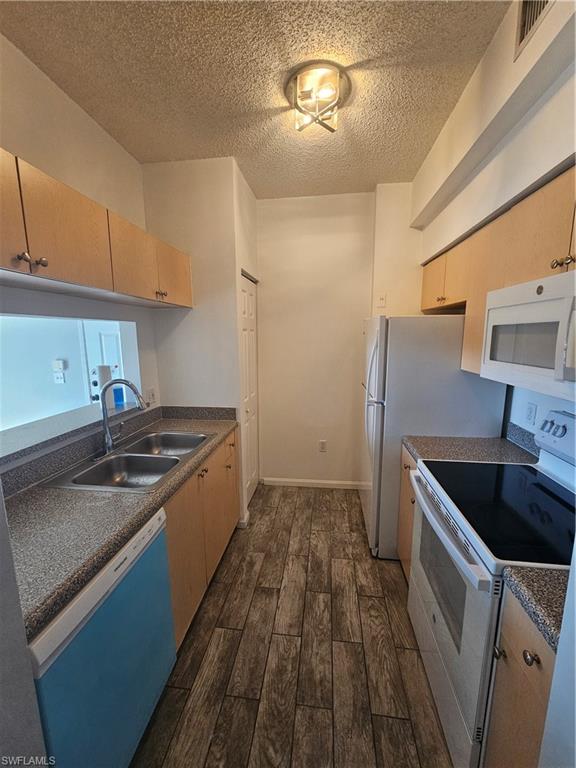 1200 Reserve Way, Unit 302 Naples, FL 34105 - Photo 9 of 15 a kitchen with a stove and a sink
