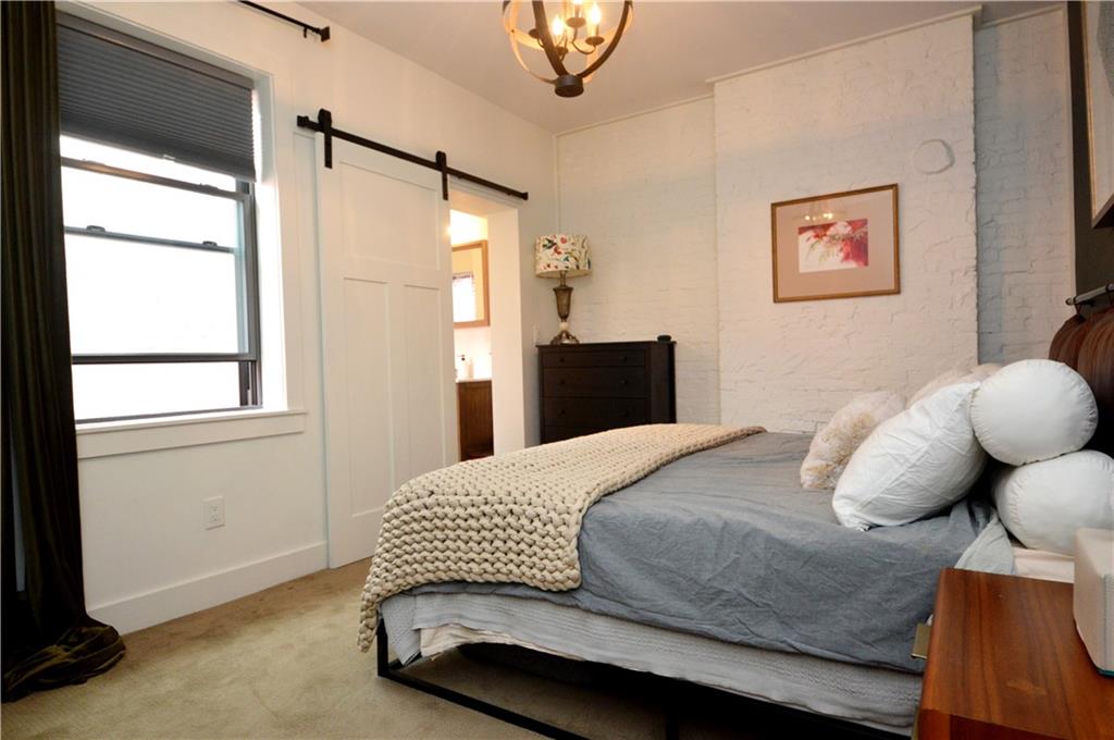 99 South 13th Street Pittsburgh, PA 15203 - Photo 24 of 50 a bedroom with a bed and wooden floor