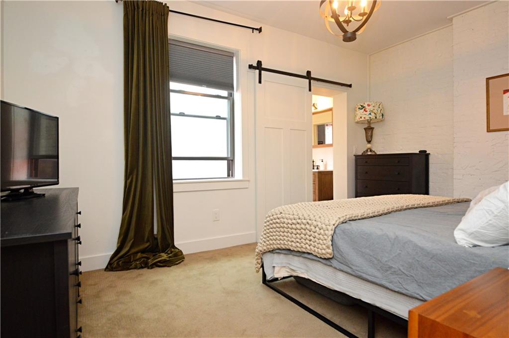 99 South 13th Street Pittsburgh, PA 15203 - Photo 26 of 50 a bedroom with a bed and a flat tv screen