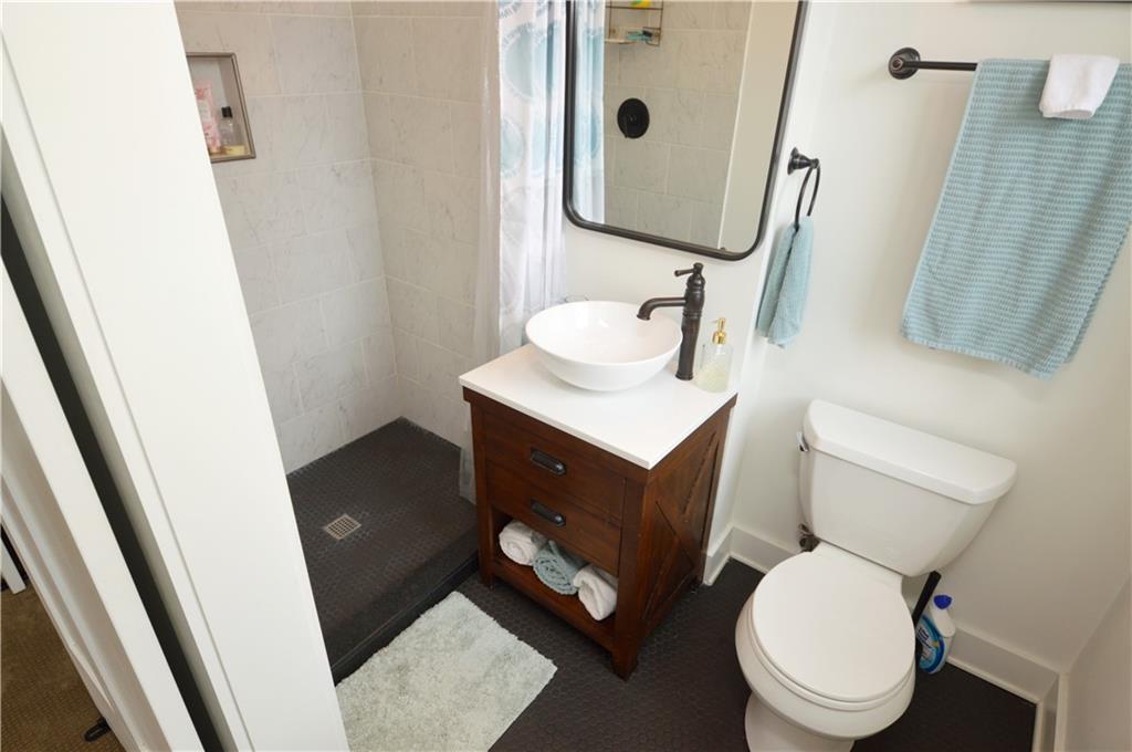 99 South 13th Street Pittsburgh, PA 15203 - Photo 36 of 50 a bathroom with a toilet sink and mirror