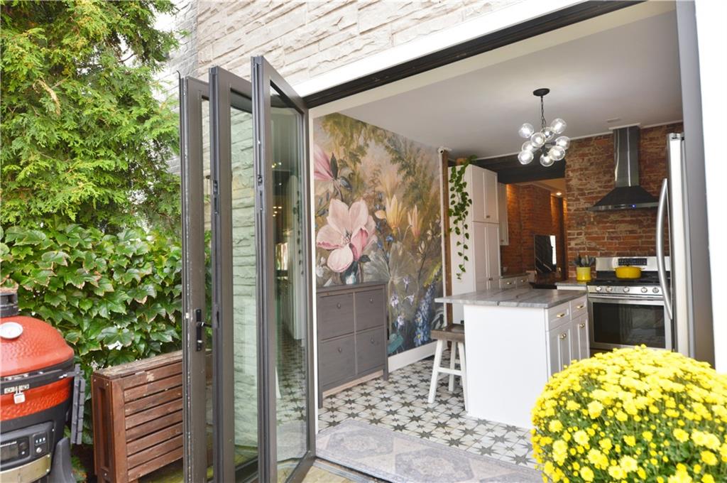 99 South 13th Street Pittsburgh, PA 15203 - Photo 47 of 50 a kitchen with a chandelier and wooden floor