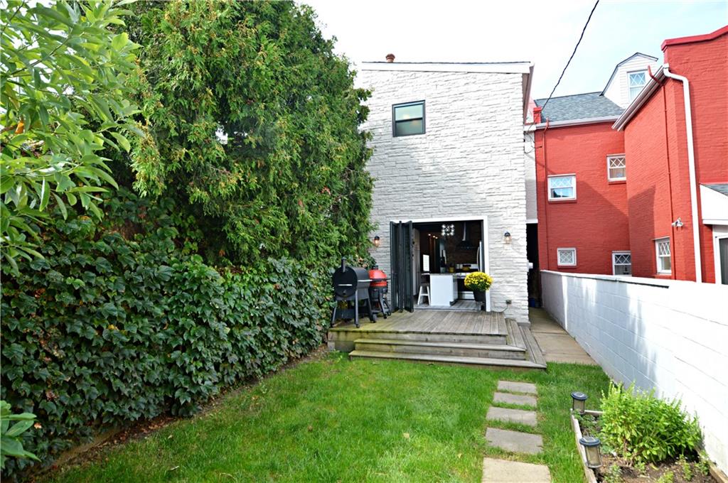 99 South 13th Street Pittsburgh, PA 15203 - Photo 50 of 50 a front view of a house with a garden and bench