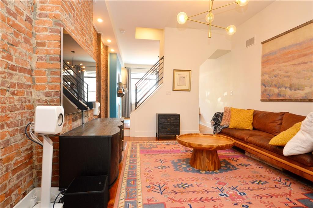 99 South 13th Street Pittsburgh, PA 15203 - Photo 8 of 50 a living room with furniture a rug and a fireplace