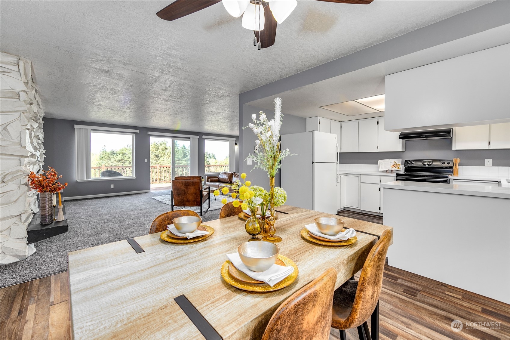 4751 Southeast Horstman Road Port Orchard, WA 98366 - Photo 13 of 40 a view of a dining room with furniture a chandelier and wooden floor