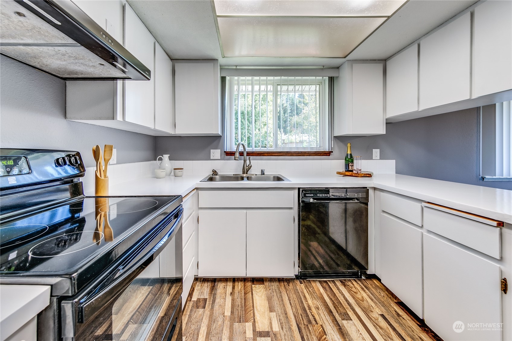 4751 Southeast Horstman Road Port Orchard, WA 98366 - Photo 14 of 40 a kitchen with a sink stove top oven and cabinets