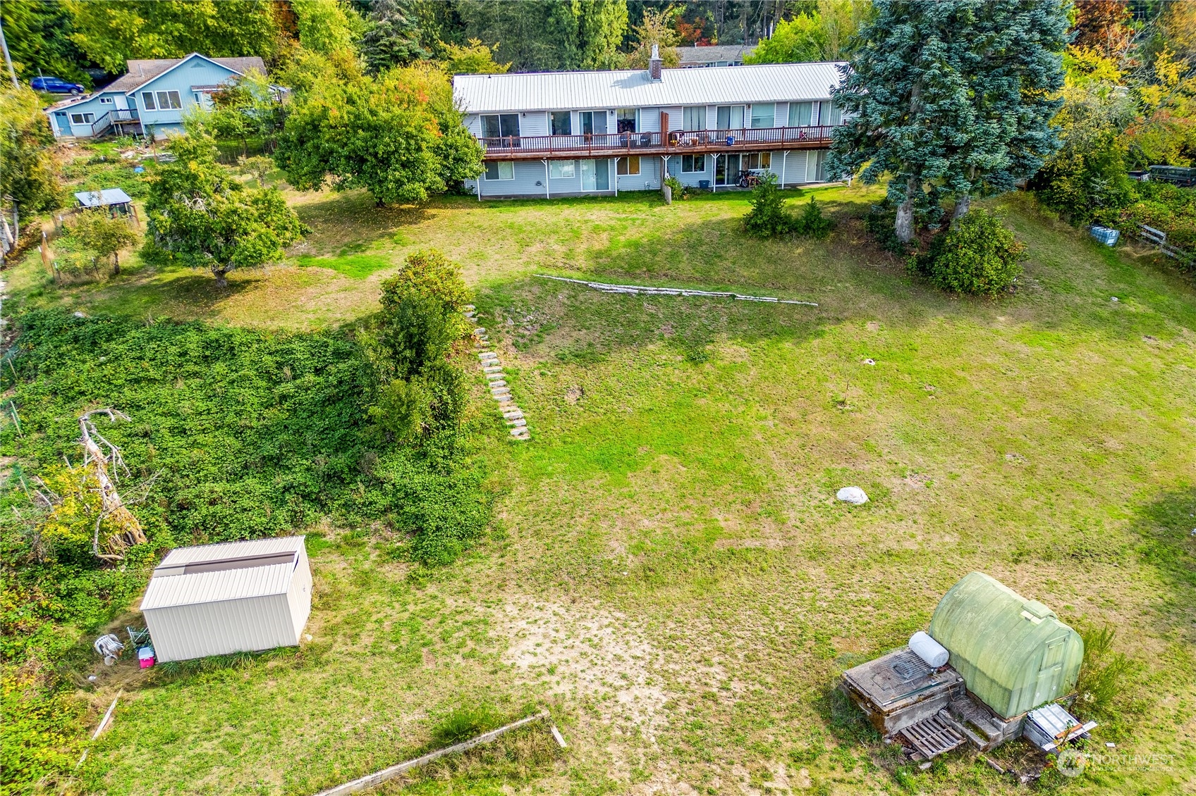 4751 Southeast Horstman Road Port Orchard, WA 98366 - Photo 30 of 40 a view of a swimming pool with lawn chairs and plants