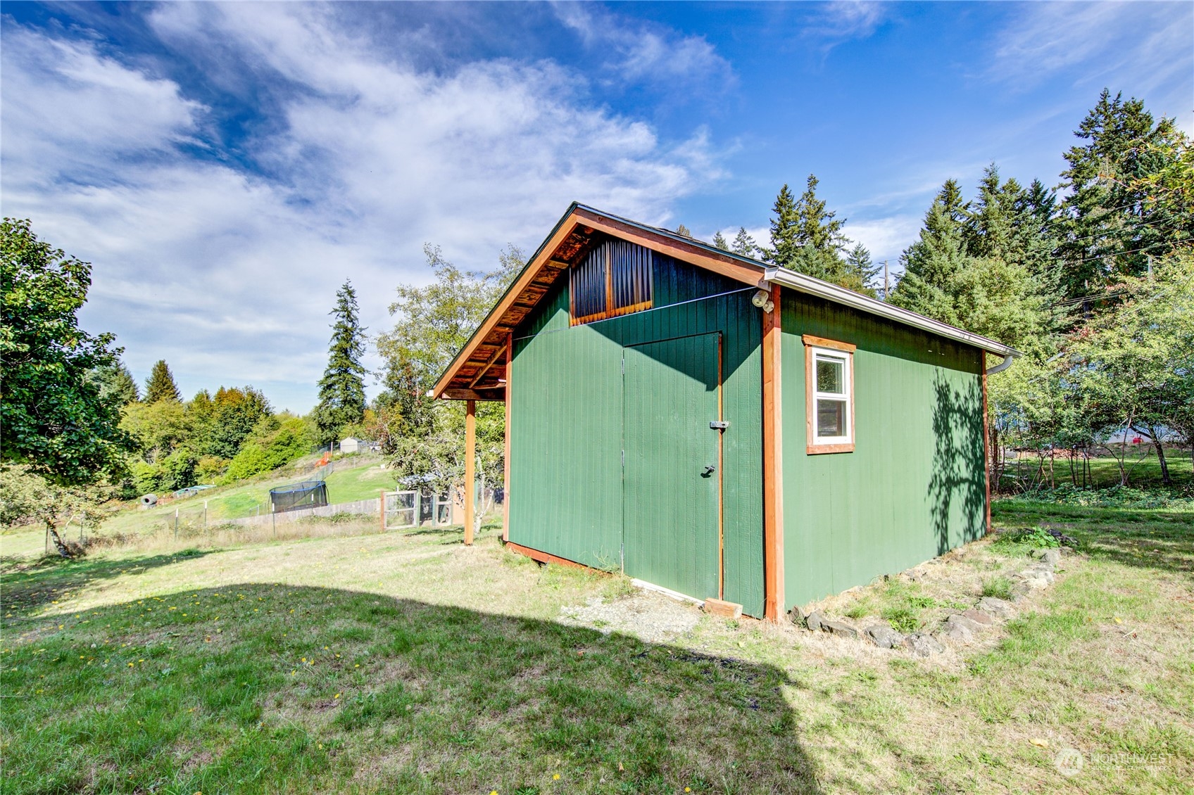 4751 Southeast Horstman Road Port Orchard, WA 98366 - Photo 31 of 40 a backyard of a house with lots of green space