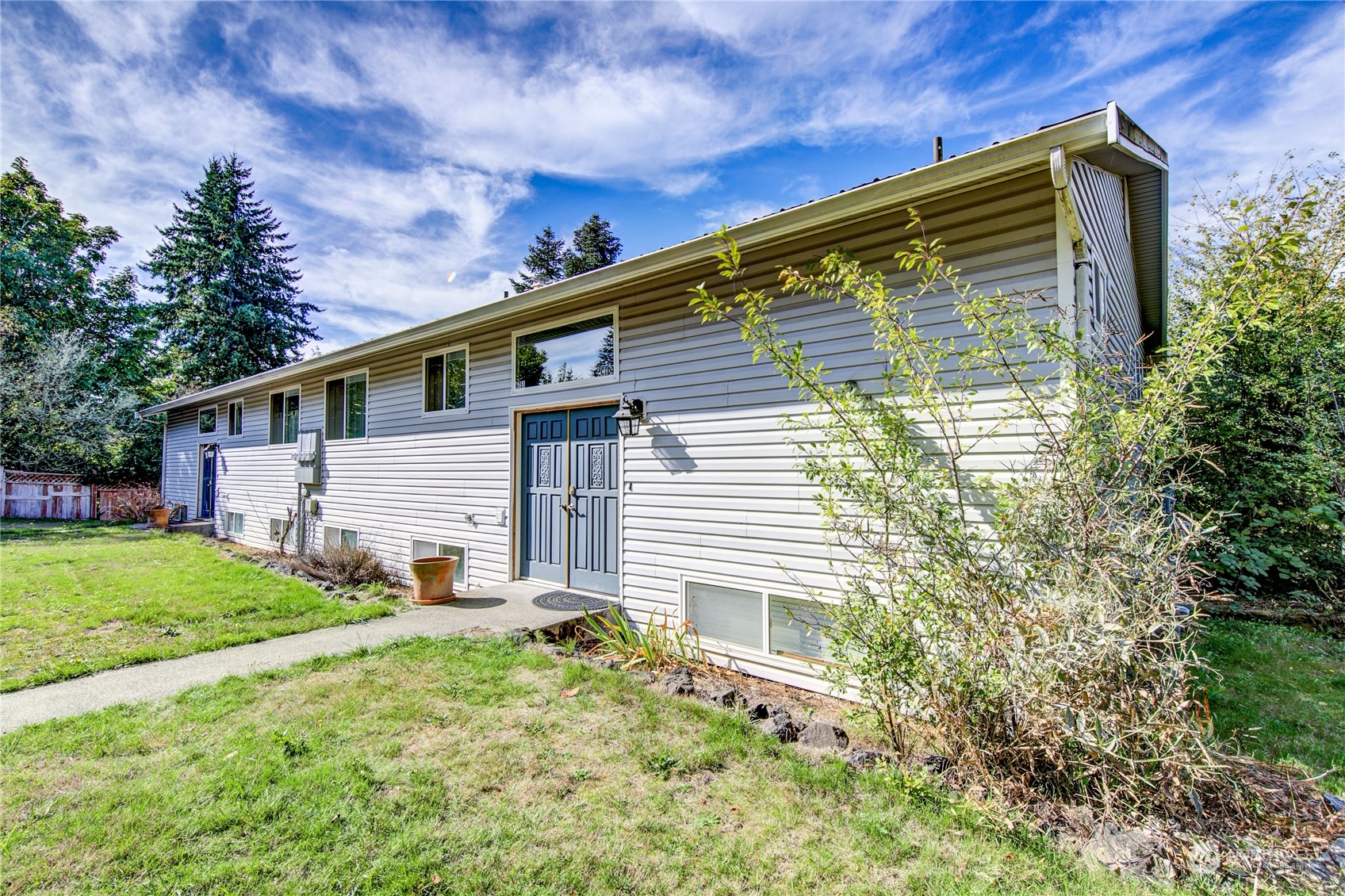 4751 Southeast Horstman Road Port Orchard, WA 98366 - Photo 4 of 40 a view of backyard with plants and a large tree