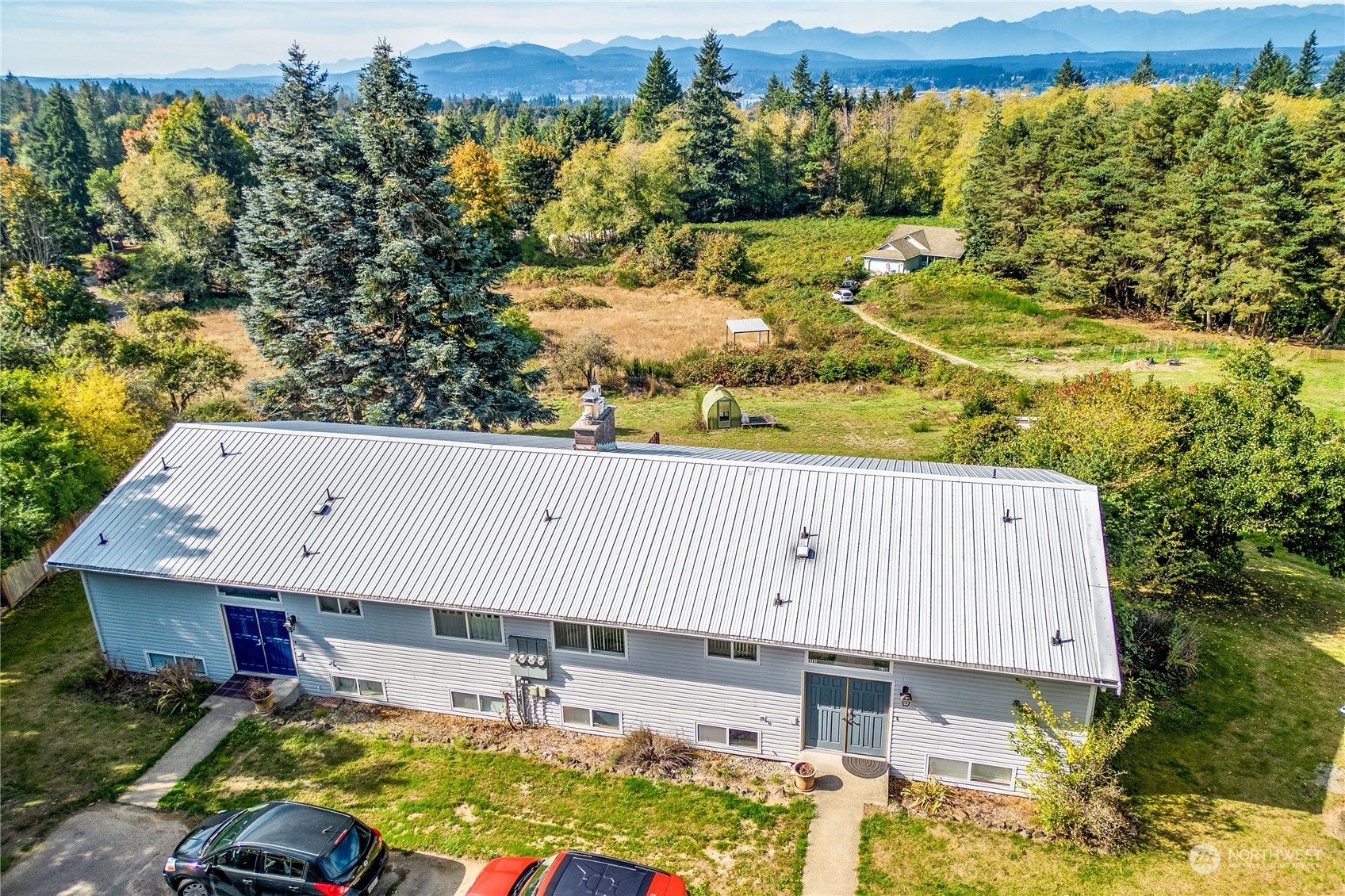 4751 Southeast Horstman Road Port Orchard, WA 98366 - Photo 6 of 40 a view of a patio with table and chairs and potted plants