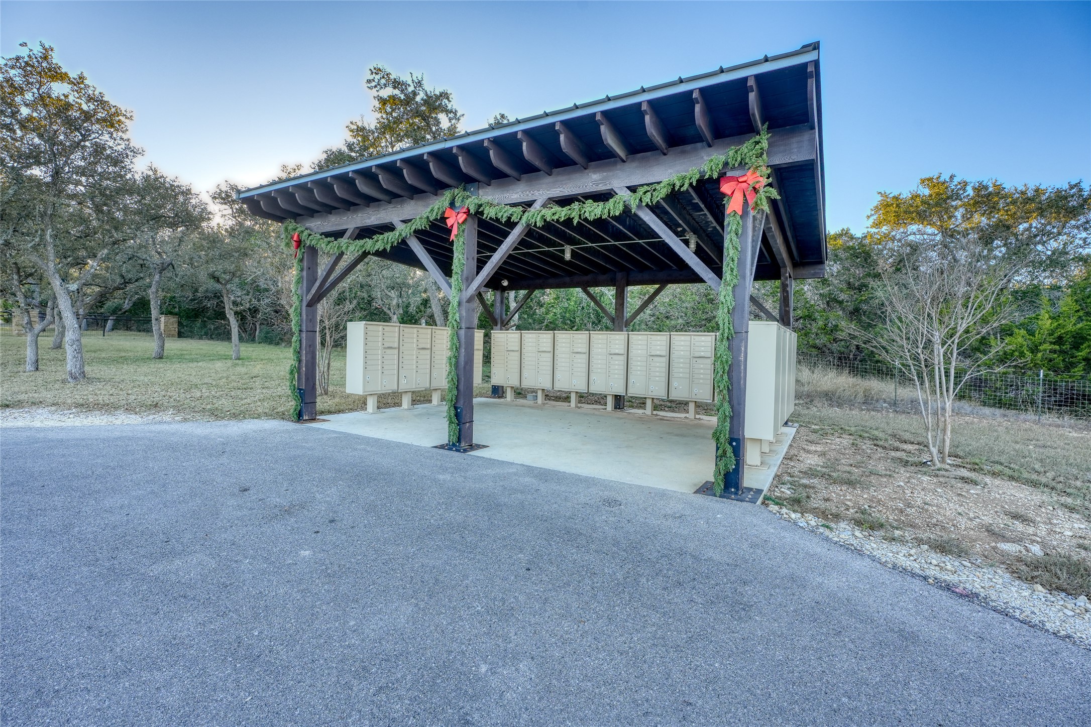 136 Falling Oak Drive Blanco, TX 78606 - Photo 18 of 19 View of home's community featuring a patio area, mail area, and asphalt driveway