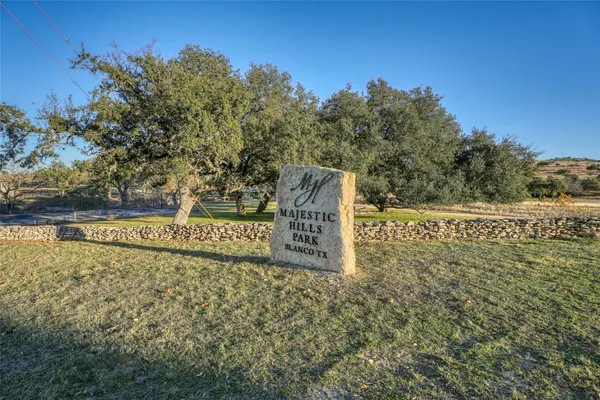 a view of a field with trees in the background