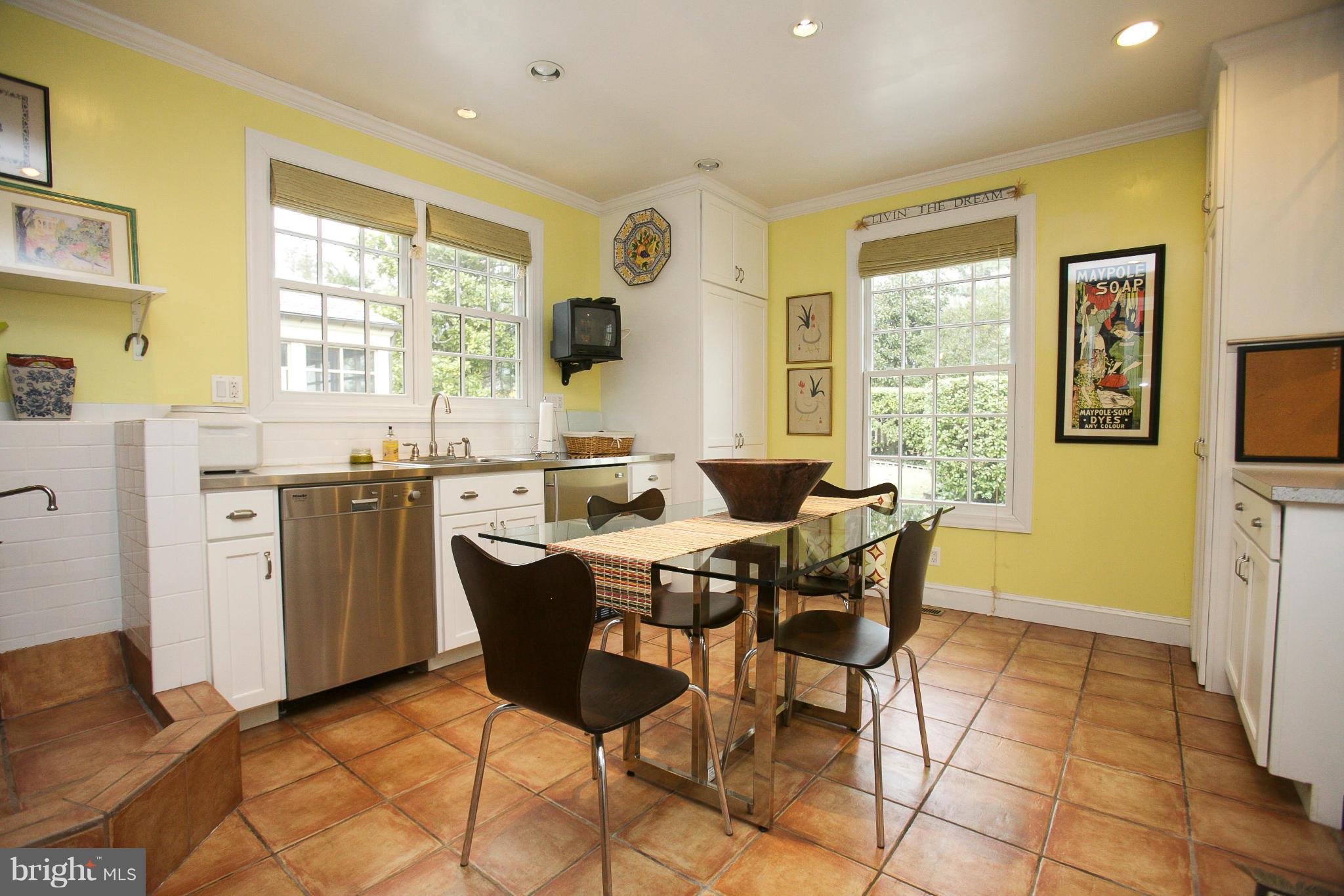214 Goodale Road Baltimore, MD 21212 - Photo 12 of 30 a dining room with stainless steel appliances a table and chairs