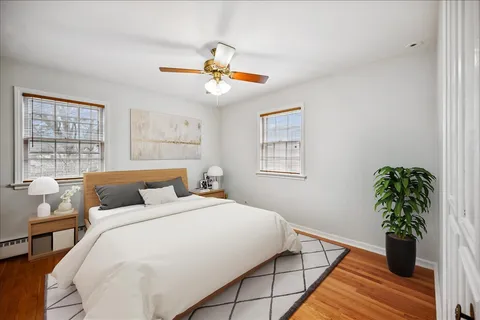 a bedroom with a large bed and a potted plant