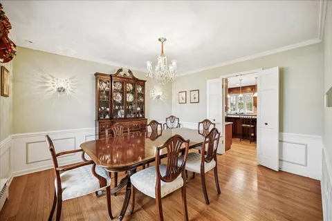 a view of a dining room with furniture wooden floor and chandelier