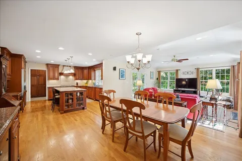 a view of a dining room with furniture and chandelier