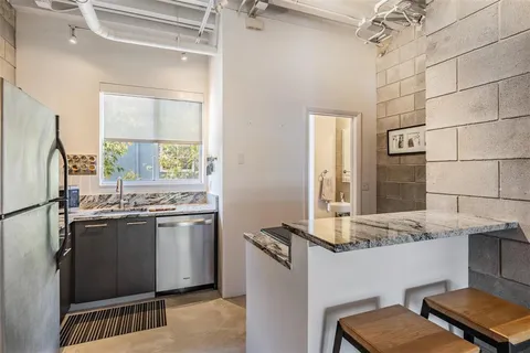 a kitchen with a sink a counter space and appliances