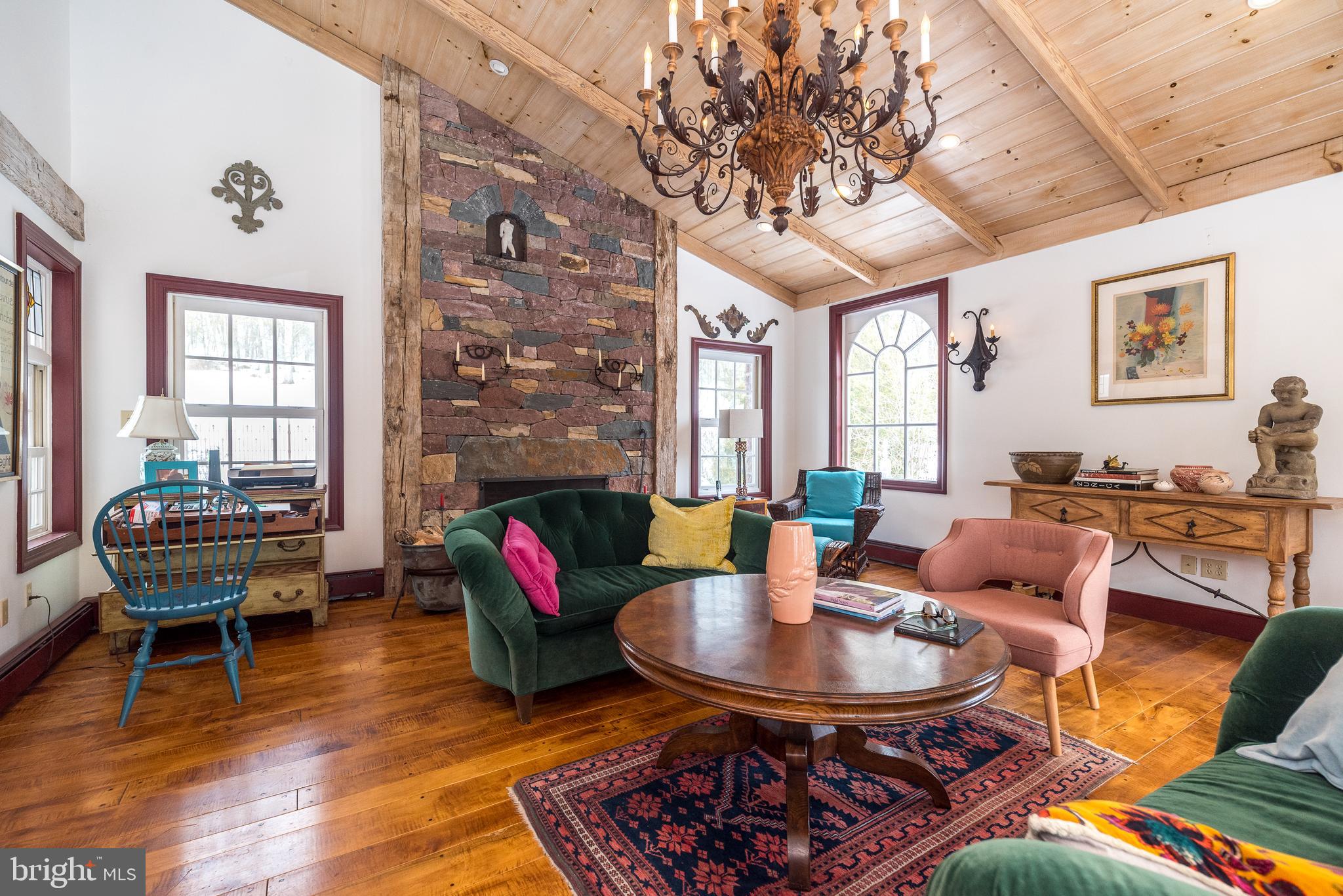23 Lily Valley Road Erwinna, PA 18920 - Photo 31 of 81 a living room with furniture a fireplace and a table