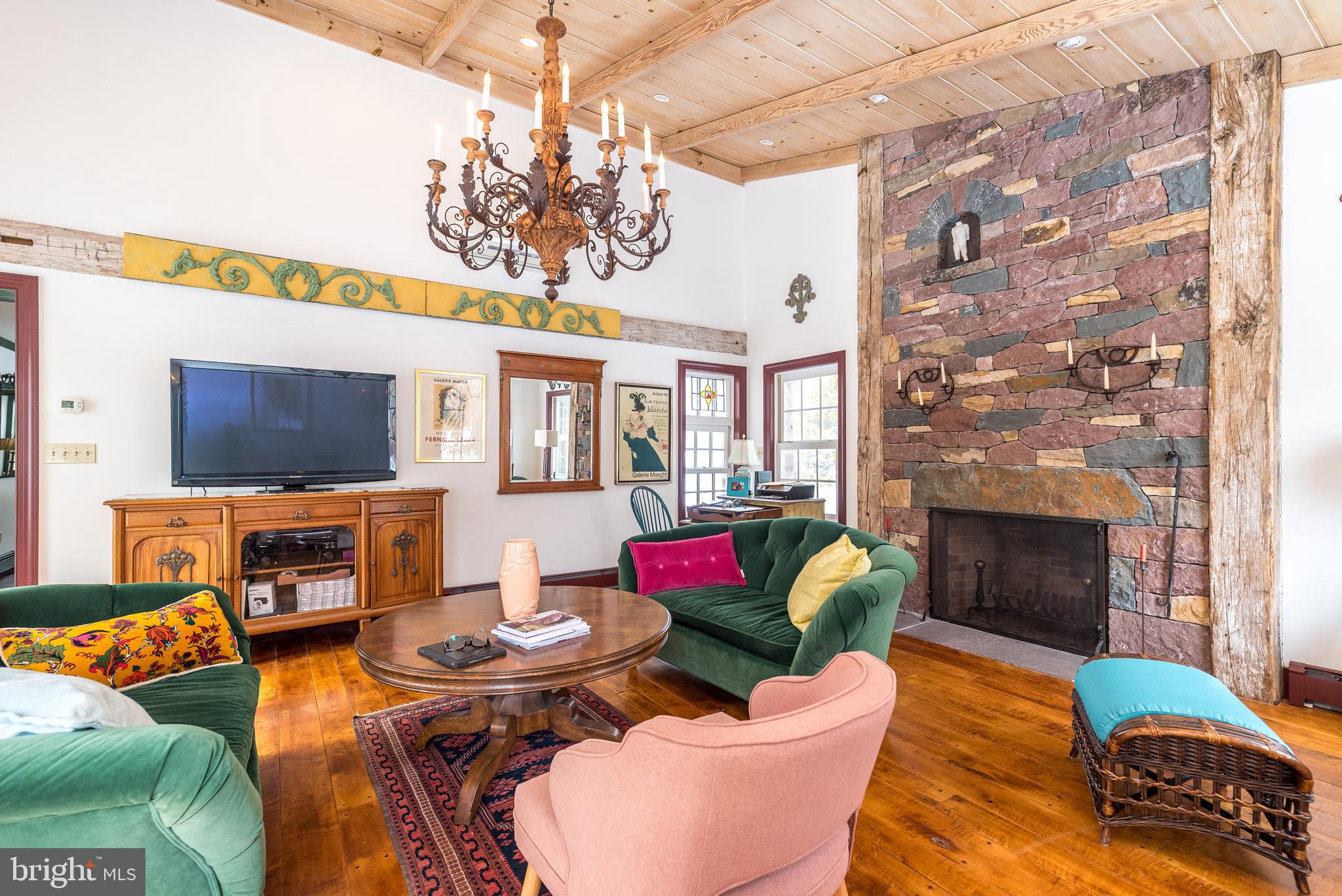 23 Lily Valley Road Erwinna, PA 18920 - Photo 32 of 81 a living room with fireplace furniture and a flat screen tv
