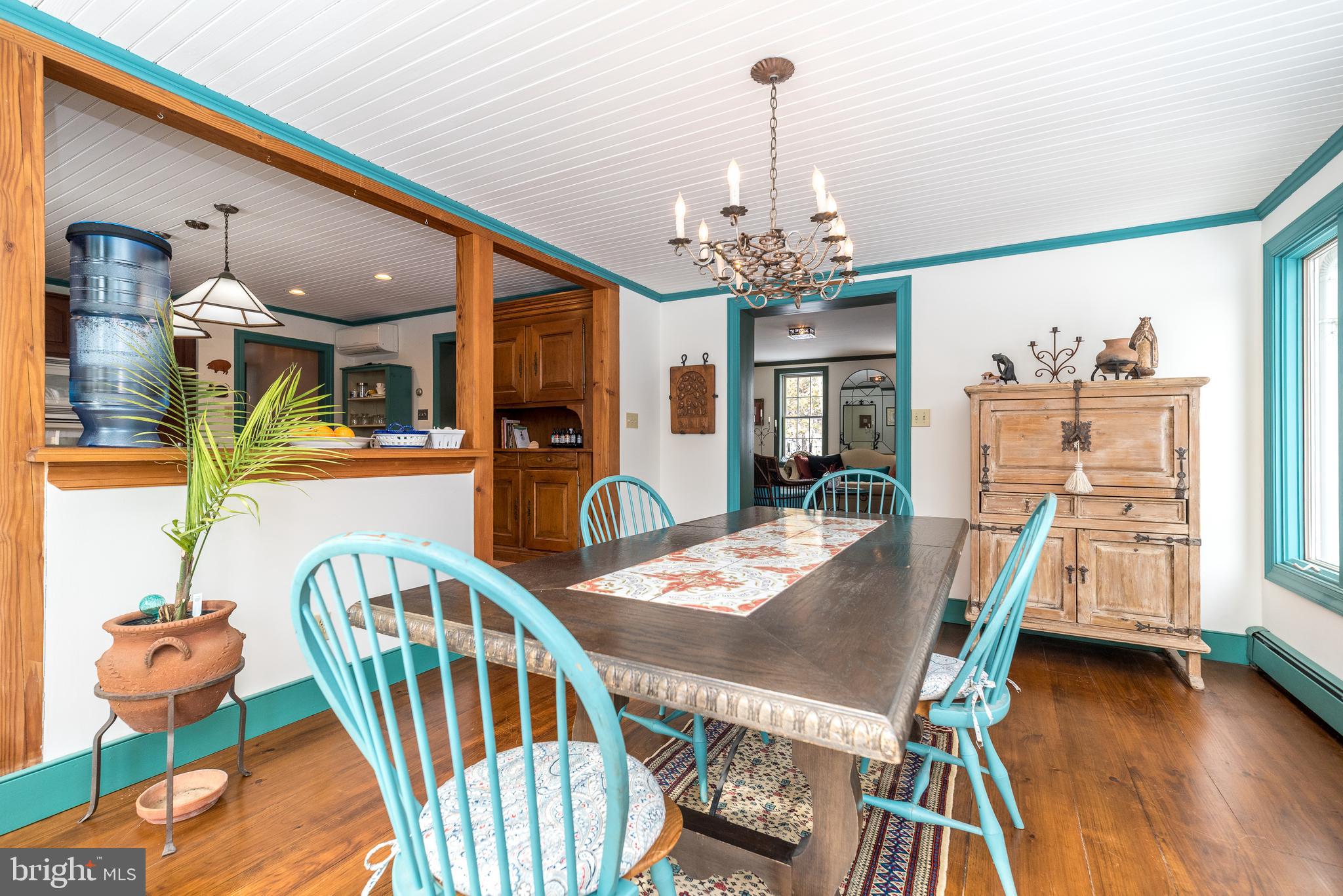 23 Lily Valley Road Erwinna, PA 18920 - Photo 51 of 81 a view of a dining room with furniture wooden floor and chandelier