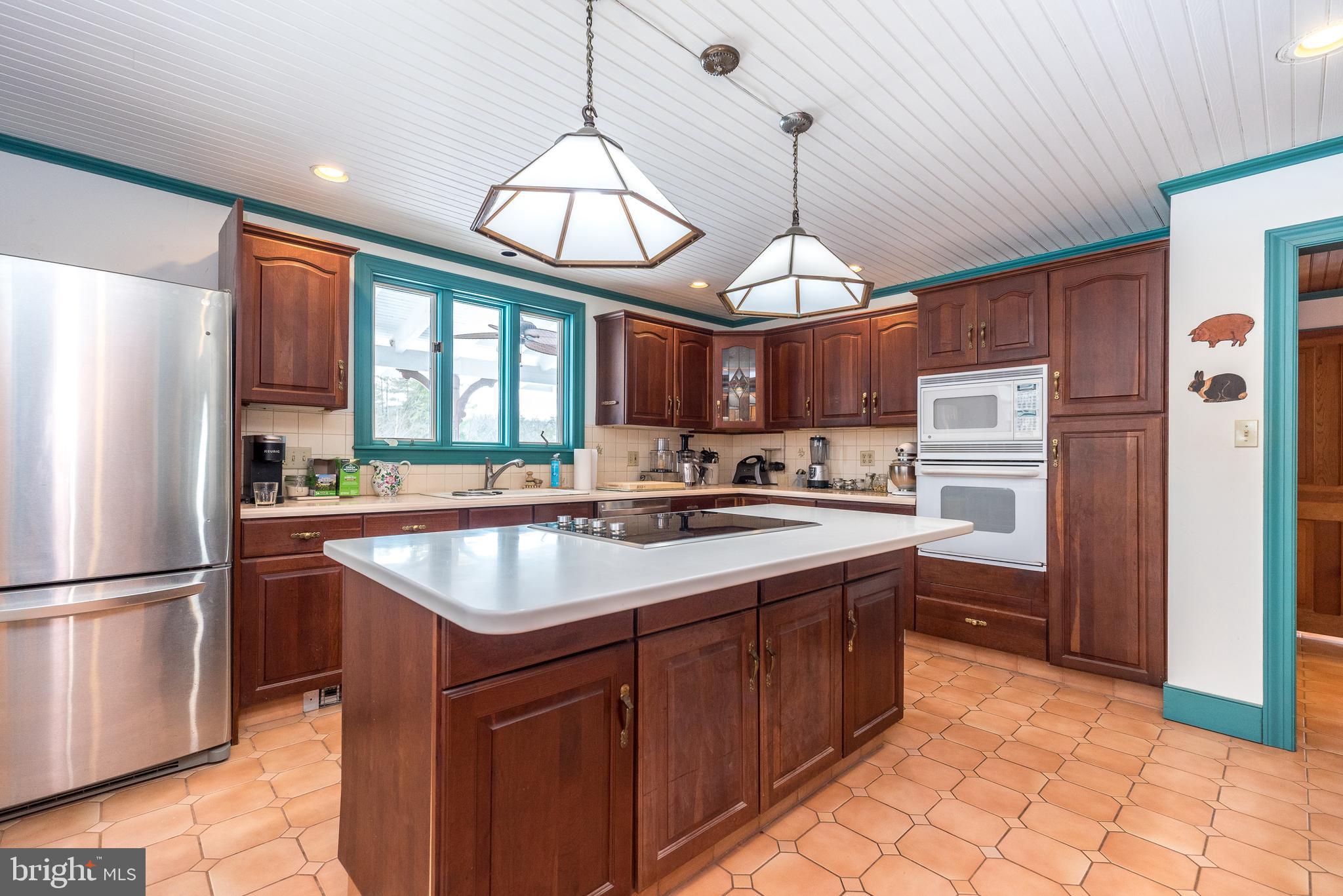 23 Lily Valley Road Erwinna, PA 18920 - Photo 52 of 81 a kitchen with stainless steel appliances granite countertop a sink stove and refrigerator