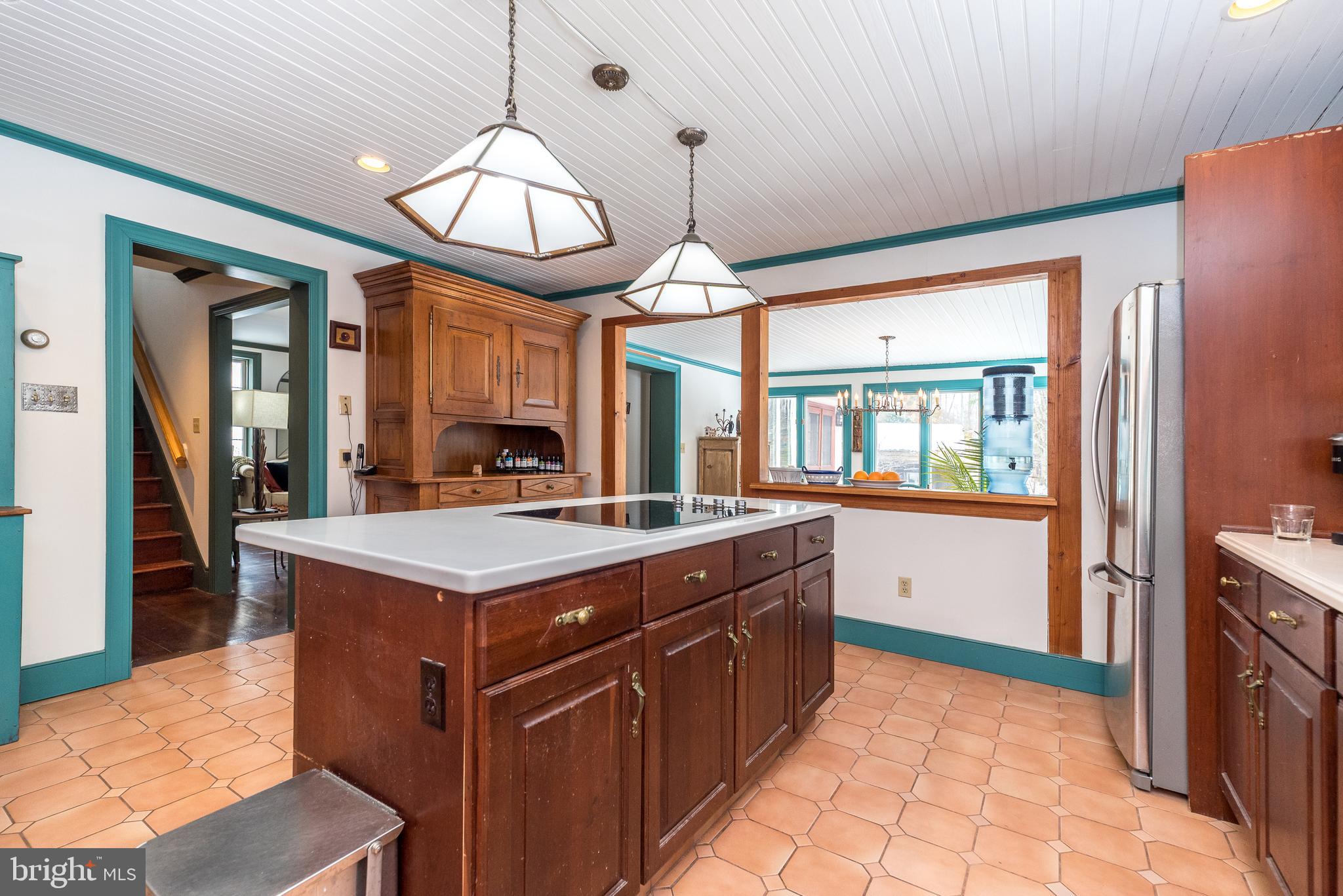 23 Lily Valley Road Erwinna, PA 18920 - Photo 54 of 81 a kitchen with a stove top oven and a chandelier