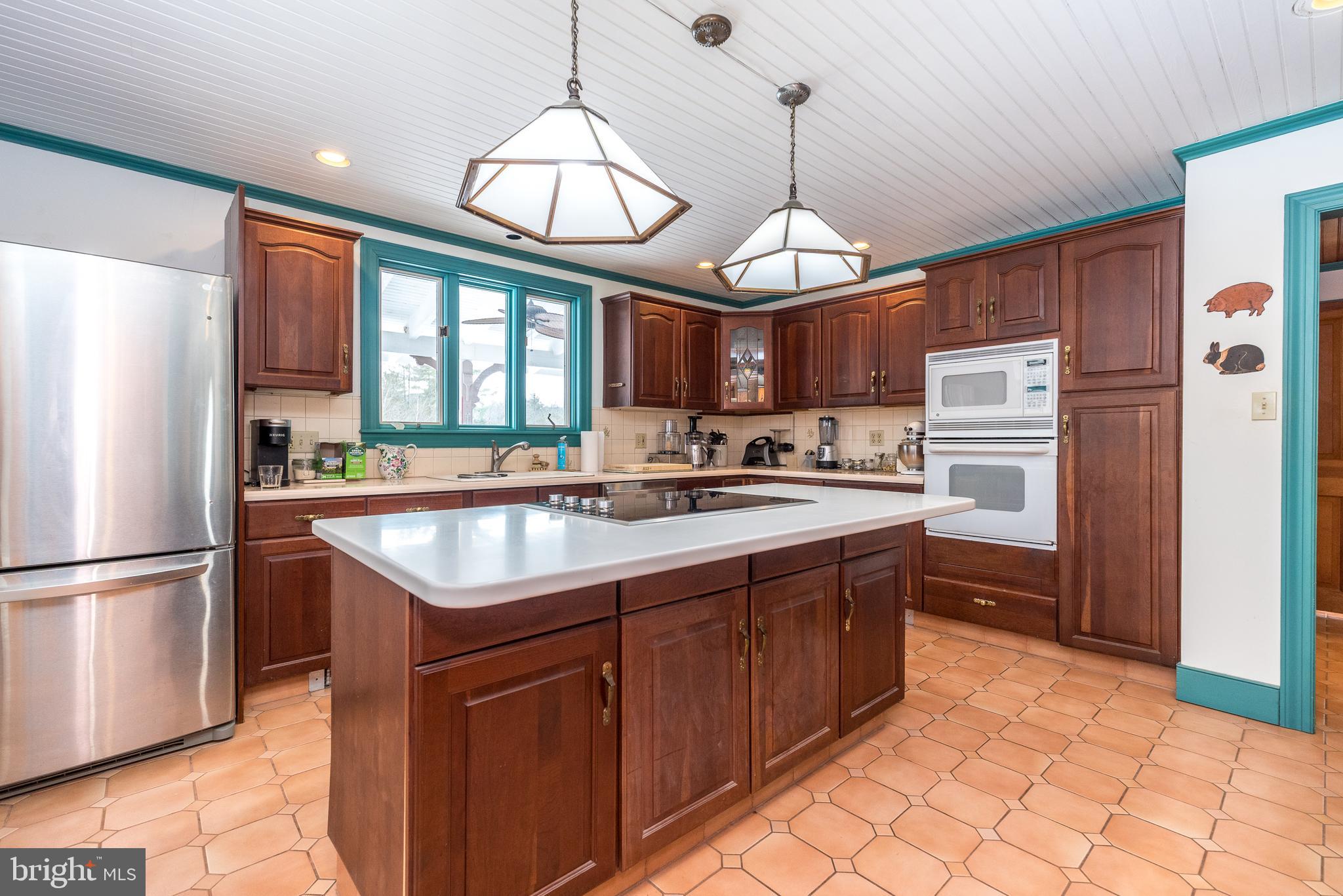 23 Lily Valley Road Erwinna, PA 18920 - Photo 56 of 81 a kitchen with stainless steel appliances granite countertop a sink a stove and refrigerator