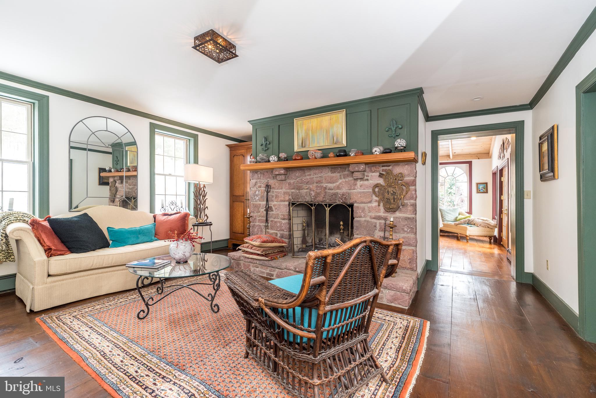 23 Lily Valley Road Erwinna, PA 18920 - Photo 62 of 81 a living room with furniture a fireplace and a floor to ceiling window