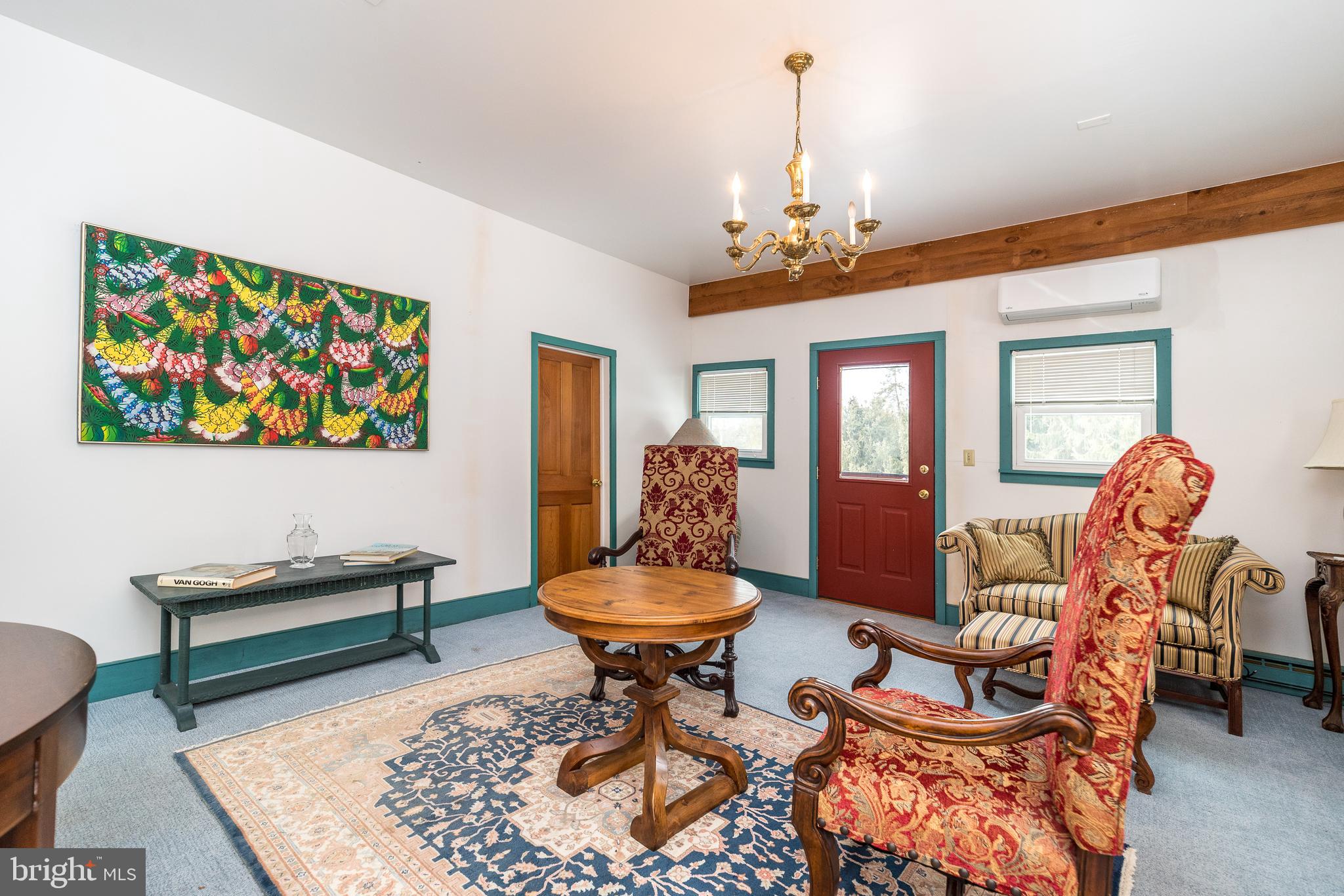 23 Lily Valley Road Erwinna, PA 18920 - Photo 70 of 81 a living room with furniture a rug and a chandelier