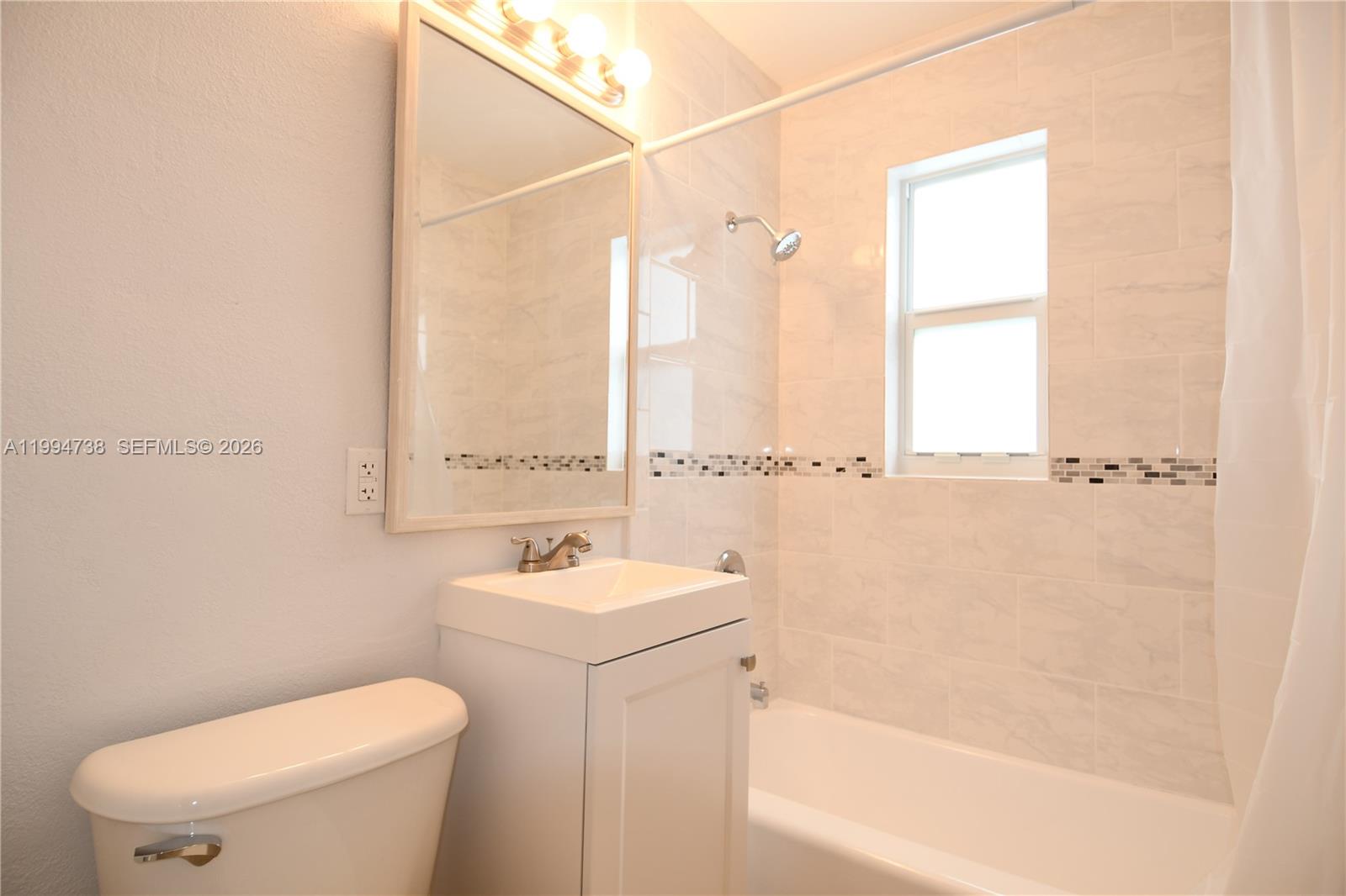 1398 Northwest 61st Street, Unit 10 Miami, FL 33142 - Photo 8 of 8 a bathroom with a sink a toilet and shower
