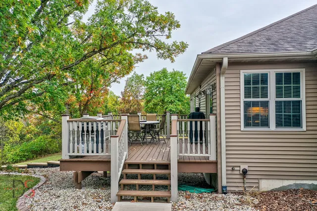 a roof deck with table and chairs and wooden floor