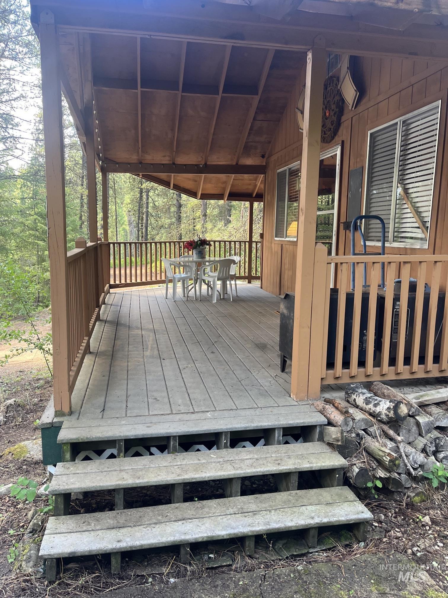 39 Mayflower Mine Road Placerville, ID 83666 - Photo 5 of 36 Expansive covered deck featuring wood-finish flooring, wood railings, and a wood plank ceiling