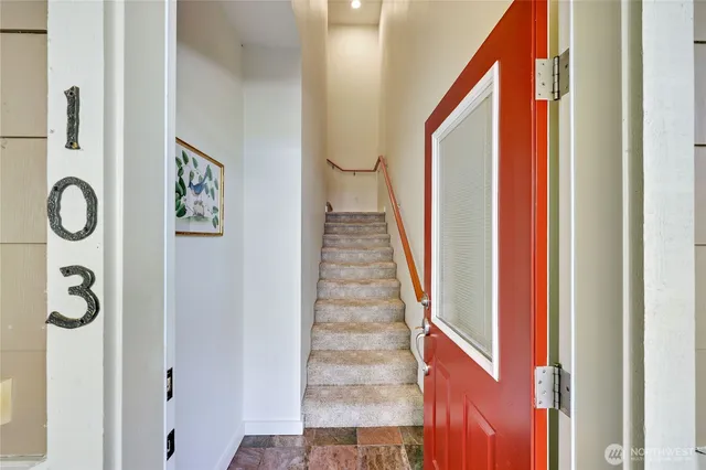 a view of a hallway with wooden floor and entryway