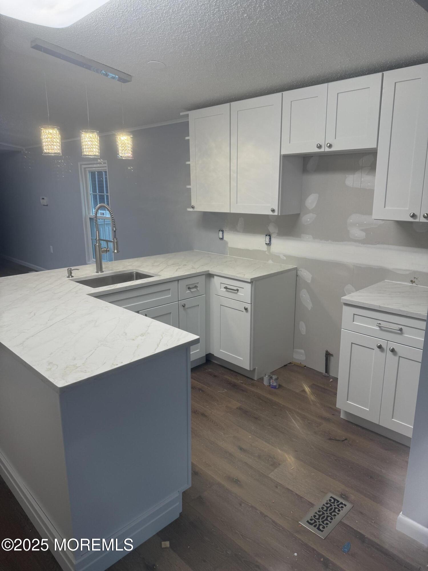 18 Ruffian Way Howell, NJ 07731 - Photo 5 of 9 a kitchen with granite countertop white cabinets and white appliances