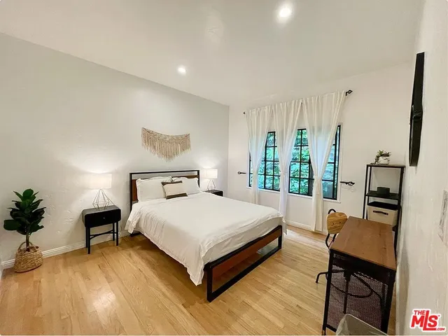 a spacious bedroom with a bed and a table in it