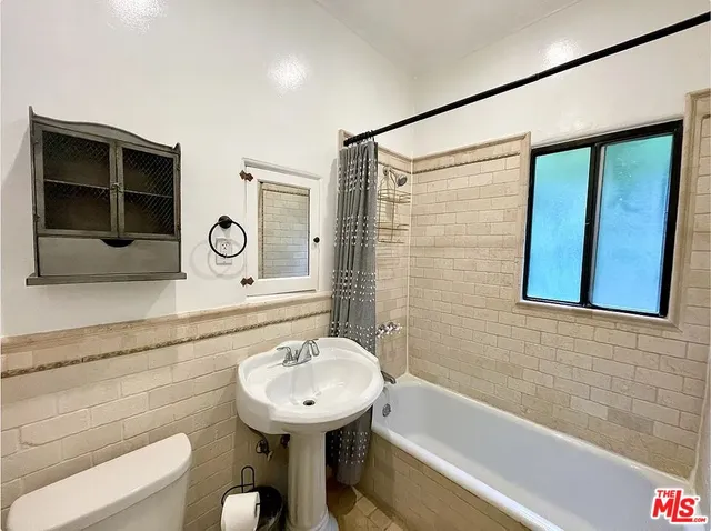 a bathroom with a sink a toilet and bathtub