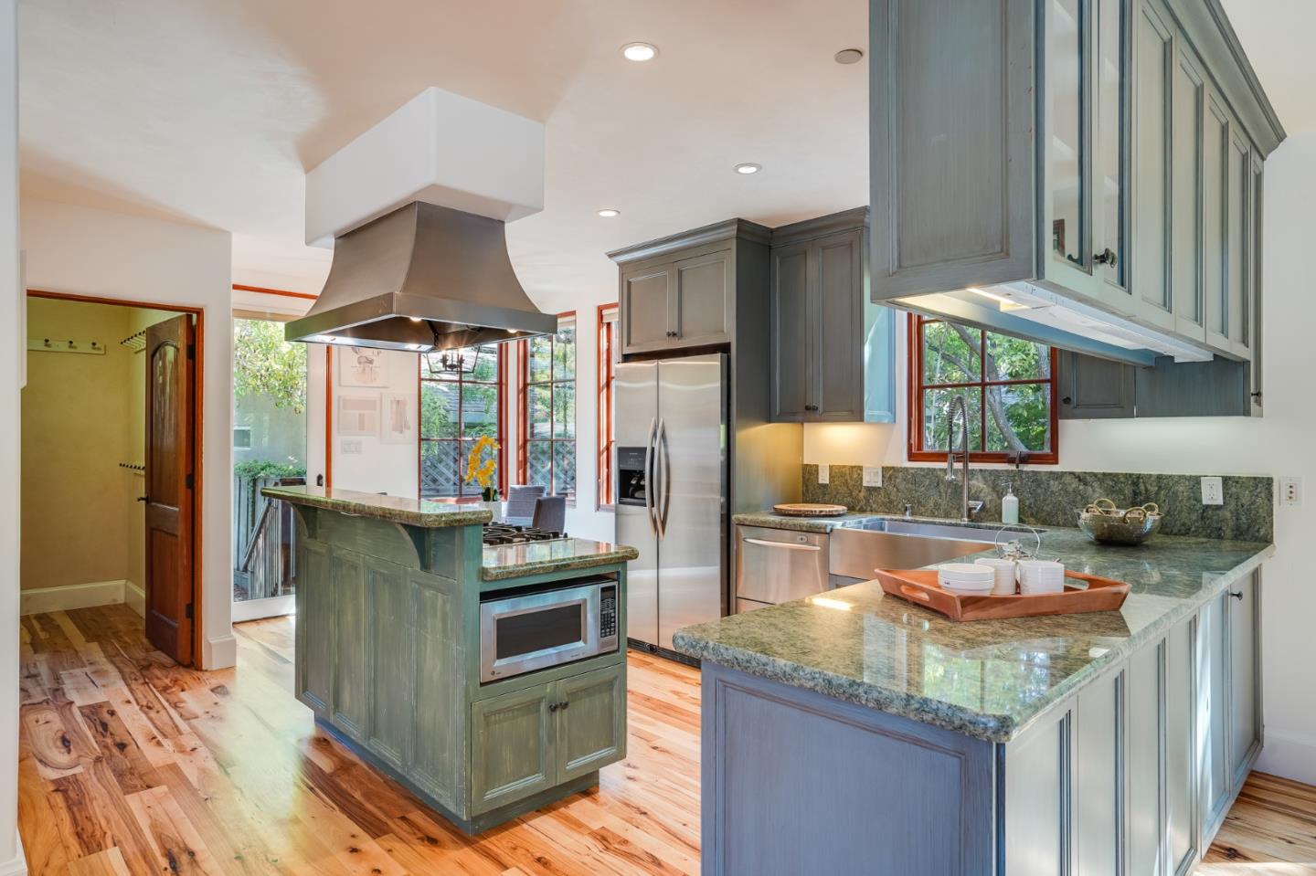 720 Edgewood Road San Mateo, CA 94402 - Photo 18 of 56 a kitchen with stainless steel appliances granite countertop a sink stove and refrigerator