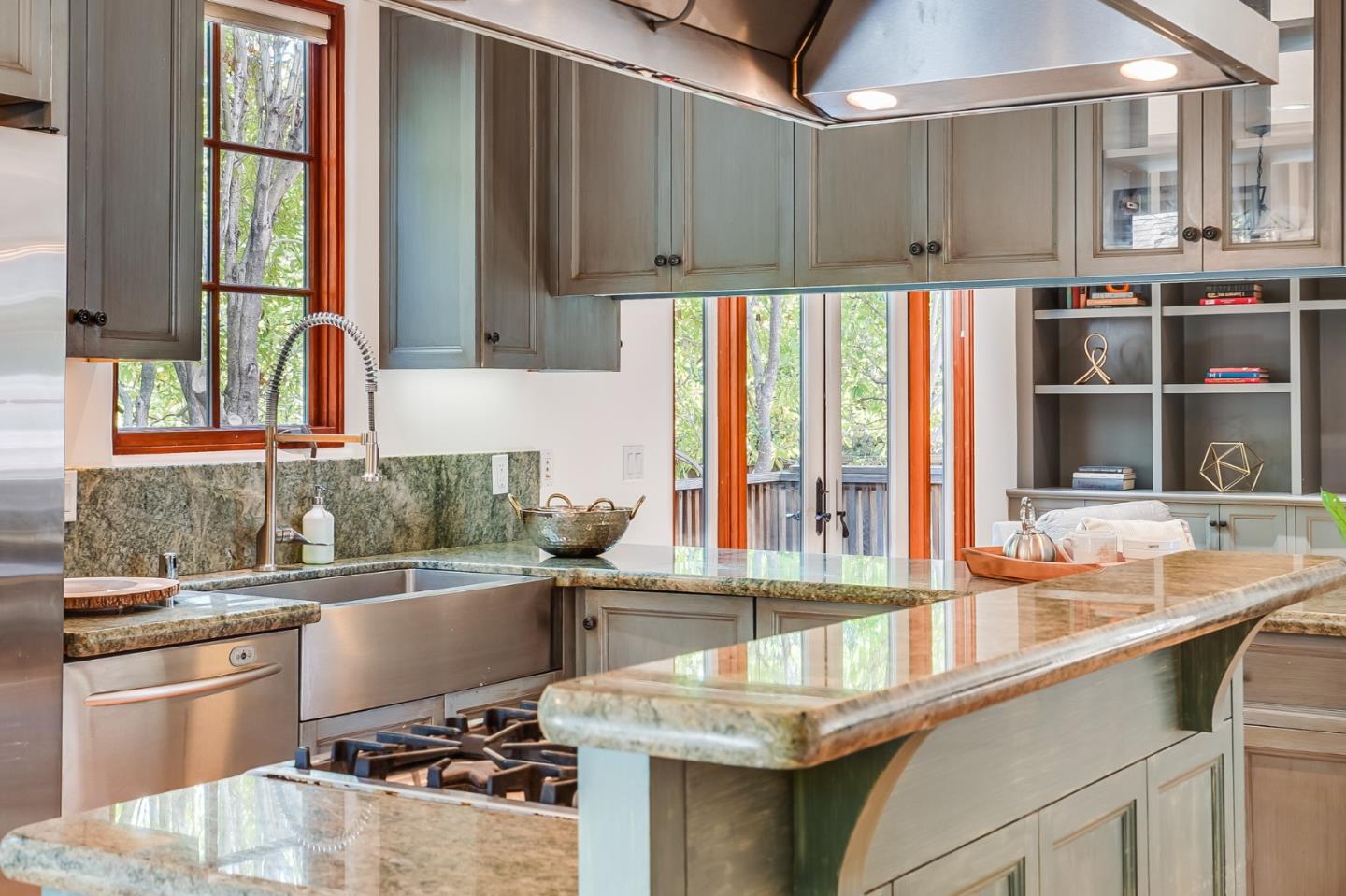720 Edgewood Road San Mateo, CA 94402 - Photo 20 of 56 a kitchen with stainless steel appliances granite countertop a sink and a stove