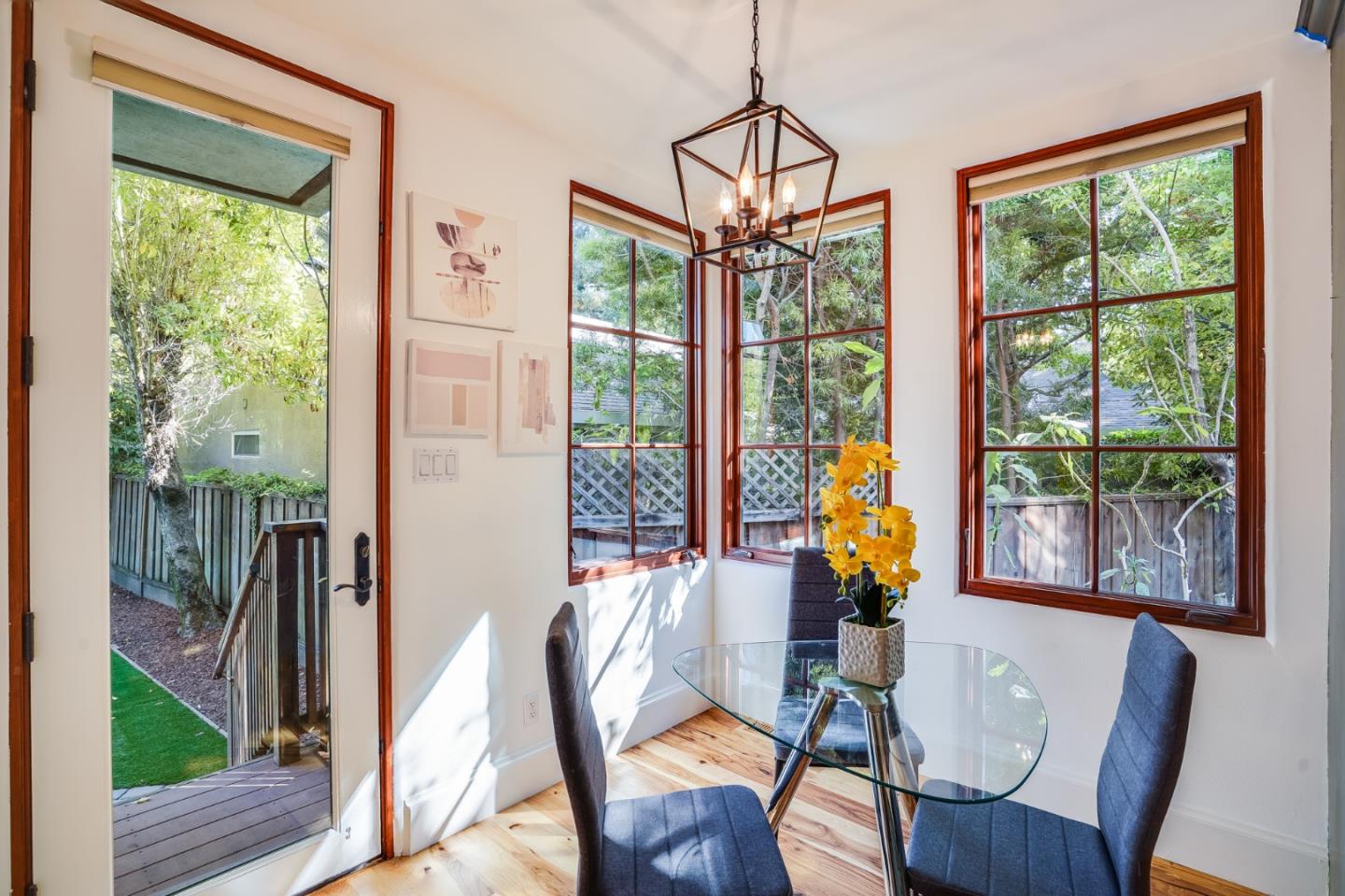 720 Edgewood Road San Mateo, CA 94402 - Photo 22 of 56 a dining room with wooden floor windows wooden floor and a chandelier