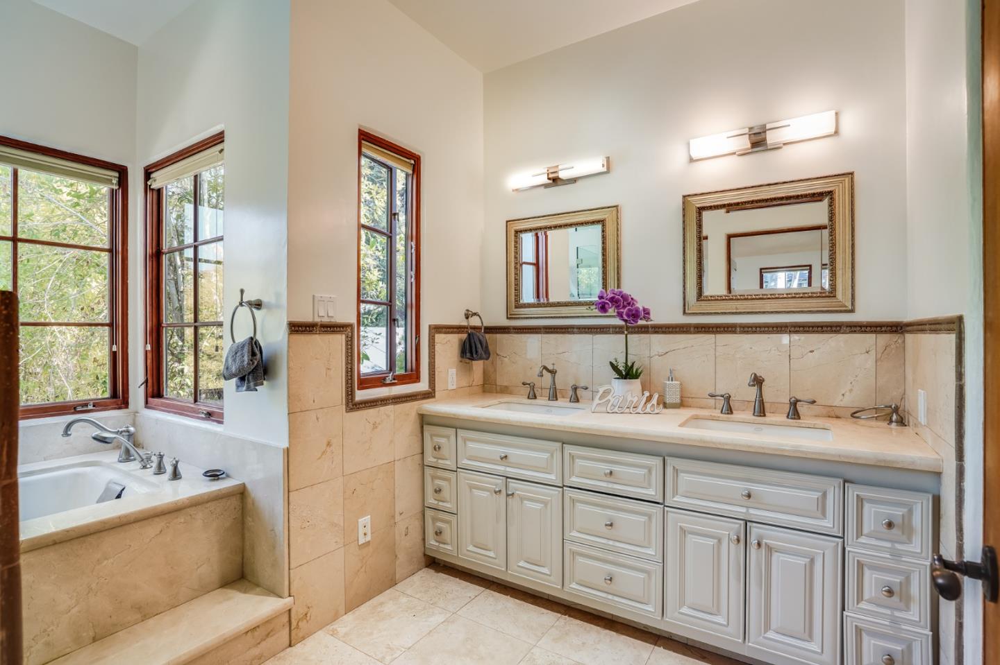720 Edgewood Road San Mateo, CA 94402 - Photo 36 of 56 a bathroom with a tub double vanity sink and mirror